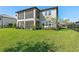 Spacious backyard featuring a screened lanai and lush green lawn at 33255 Kateland Dr, Wesley Chapel, FL 33545
