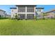 Expansive backyard featuring a covered lanai and lush green lawn at 33255 Kateland Dr, Wesley Chapel, FL 33545
