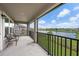 A spacious balcony overlooking a tranquil pond, enhancing outdoor living experience at 33255 Kateland Dr, Wesley Chapel, FL 33545