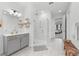 Bathroom featuring a double sink vanity, walk-in shower, and marble tile flooring at 33255 Kateland Dr, Wesley Chapel, FL 33545