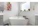 Close up of a soaking tub with fixtures, shelves, and a view from the window at 33255 Kateland Dr, Wesley Chapel, FL 33545
