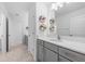 Bathroom with grey vanity, white countertop, large mirror, tiled floor, and modern fixtures at 33255 Kateland Dr, Wesley Chapel, FL 33545