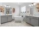 Bathroom with double sink vanity, soaking tub, tile flooring, and stylish fixtures at 33255 Kateland Dr, Wesley Chapel, FL 33545