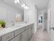 A bright bathroom boasts a dual sink vanity with modern hardware and a marble countertop at 33255 Kateland Dr, Wesley Chapel, FL 33545
