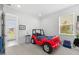 Bright bedroom features neutral walls, a large window, and themed decor at 33255 Kateland Dr, Wesley Chapel, FL 33545
