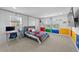 Bright bedroom with a colorful design, featuring a desk and views of the pond at 33255 Kateland Dr, Wesley Chapel, FL 33545