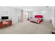 Spacious bedroom features bright natural light, neutral carpet, vibrant pink accents, and ample closet space at 33255 Kateland Dr, Wesley Chapel, FL 33545