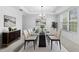 Bright dining room features a glass table, elegant chairs, and modern decor at 33255 Kateland Dr, Wesley Chapel, FL 33545