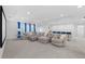 Spacious living room with a comfortable sofa, blue curtains, and a home theater at 33255 Kateland Dr, Wesley Chapel, FL 33545