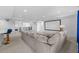 Spacious living room with a comfortable sofa, wet bar, and a home theater at 33255 Kateland Dr, Wesley Chapel, FL 33545