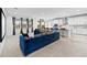 Open living space with a modern kitchen, barstools, and comfortable sectional sofa at 33255 Kateland Dr, Wesley Chapel, FL 33545