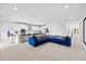 Spacious open-concept living room connected to a modern kitchen with barstool seating at 33255 Kateland Dr, Wesley Chapel, FL 33545