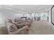 Spacious living room with a comfortable sofa, an island, and a home theater at 33255 Kateland Dr, Wesley Chapel, FL 33545