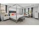 Bright bedroom with large bed, seating area, and stylish decor at 33255 Kateland Dr, Wesley Chapel, FL 33545