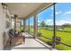 Relaxing screened patio featuring comfortable seating and views of the lake at 33255 Kateland Dr, Wesley Chapel, FL 33545