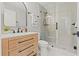 Updated bathroom featuring wood vanity with stone countertop and walk-in shower with tile surround at 4012 Marine Pkwy, New Port Richey, FL 34652