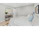 Bright bedroom featuring neutral walls and a side table with a modern lamp at 4012 Marine Pkwy, New Port Richey, FL 34652