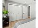 Bedroom featuring white closet doors and a leafy houseplant on an end table at 4012 Marine Pkwy, New Port Richey, FL 34652
