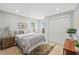 Cozy bedroom featuring neutral tones, white closet doors, and a bedside table with a lamp at 4012 Marine Pkwy, New Port Richey, FL 34652