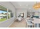 Bright dining area features a modern table, chairs, large windows, and water views at 4012 Marine Pkwy, New Port Richey, FL 34652