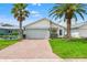 Charming single-Gathering home with a two-car garage, paved driveway, and lush lawn at 4012 Marine Pkwy, New Port Richey, FL 34652