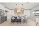 Modern kitchen with stainless steel appliances, white cabinets, and a large center island with seating at 4012 Marine Pkwy, New Port Richey, FL 34652
