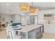 Open-concept kitchen with stainless steel appliances, large island, and adjacent living area at 4012 Marine Pkwy, New Port Richey, FL 34652