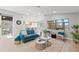 Open-concept living room with comfortable seating, views of the kitchen, and modern lighting at 4012 Marine Pkwy, New Port Richey, FL 34652