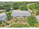 An aerial view of these homes offers a tranquil setting, surrounded by lush landscaping and a serene lake at 404 Laurel Lake Dr # 101, Venice, FL 34292