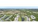 This aerial view highlights the community's serene setting amidst lush greenery and a network of ponds at 404 Laurel Lake Dr # 101, Venice, FL 34292