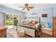 Light blue bedroom featuring a ceiling fan, sliding glass doors and windows at 404 Laurel Lake Dr # 101, Venice, FL 34292