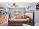 Light blue bedroom featuring a ceiling fan, sliding glass doors and windows at 404 Laurel Lake Dr # 101, Venice, FL 34292