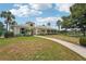 Community clubhouse surrounded by lush landscaping, offering residents a welcoming space and beautiful lake views at 404 Laurel Lake Dr # 101, Venice, FL 34292
