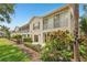 Exterior of building with well maintained lawn and landscaping at 404 Laurel Lake Dr # 101, Venice, FL 34292