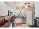Bright kitchen with stainless steel appliances, granite countertops, and a breakfast bar that opens to the Gathering room at 404 Laurel Lake Dr # 101, Venice, FL 34292