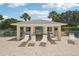 Enjoy the poolside cabana, offering a shaded retreat and comfortable seating, ideal for relaxation at 404 Laurel Lake Dr # 101, Venice, FL 34292