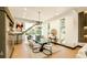 Bright dining room with modern chandelier, open staircase, and floor-to-ceiling windows with views at 4103 W Knights Ave, Tampa, FL 33611