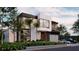 Stunning modern home featuring clean lines, large windows, and lush landscaping at 4103 W Knights Ave, Tampa, FL 33611