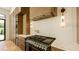 Gourmet kitchen featuring a professional-grade range and hood, complemented by elegant marble countertops at 4103 W Knights Ave, Tampa, FL 33611