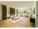 Spacious bedroom suite with floor-to-ceiling windows, a sitting area, and stylish decor at 4103 W Knights Ave, Tampa, FL 33611