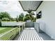 A modern outdoor kitchen features a grill, bar, and sleek cabinetry, perfect for entertaining at 4103 W Knights Ave, Tampa, FL 33611