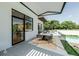 An outdoor patio with dining table, chairs, and seamless connection to the living space at 4103 W Knights Ave, Tampa, FL 33611
