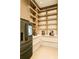 Modern walk-in pantry with sleek built-in shelving and recessed lighting, offering ample storage space at 4103 W Knights Ave, Tampa, FL 33611