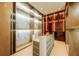 Stylish walk-in closet with custom shelving and modern display island, offering ample storage at 4103 W Knights Ave, Tampa, FL 33611