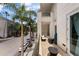 Balcony with seating area overlooking palm trees and street view at 450 Knights Run Ave # 104, Tampa, FL 33602