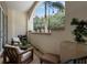 Cozy outdoor balcony with charming patio furniture and lush green scenery in a tranquil setting at 450 Knights Run Ave # 104, Tampa, FL 33602