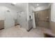 Community bathroom with a tiled shower featuring grab bars and a built-in seat for safety and accessibility at 450 Knights Run Ave # 104, Tampa, FL 33602
