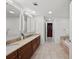 Bathroom with double vanity, neutral finishes, and ample lighting at 450 Knights Run Ave # 104, Tampa, FL 33602
