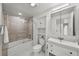 Bright bathroom with updated vanity, and a shower-over-tub with glass doors, providing a spa-like feel at 450 Knights Run Ave # 104, Tampa, FL 33602