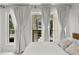 Serene bedroom with curtains and balcony view offering natural light and a relaxing atmosphere at 450 Knights Run Ave # 104, Tampa, FL 33602